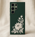 Dark green phone case with white floral design on a beige background