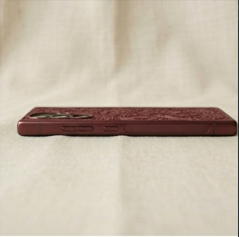 Maroon phone case on a beige fabric background