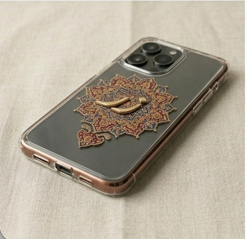 Phone case with decorative mandala design on a beige fabric background