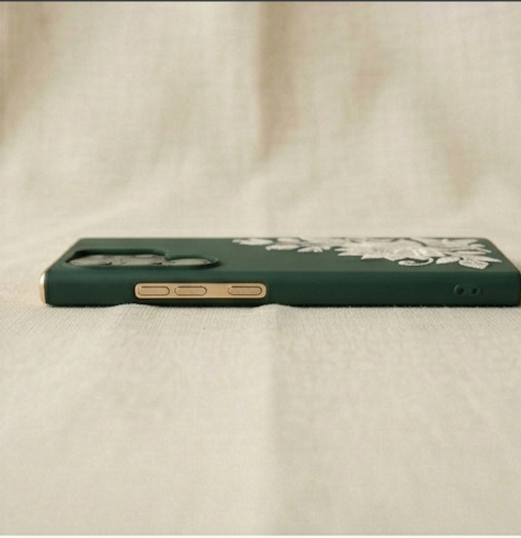 Green phone case on a beige fabric background